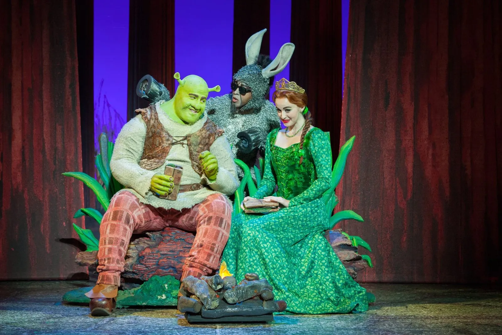 Theatrical production with costumed characters on stage